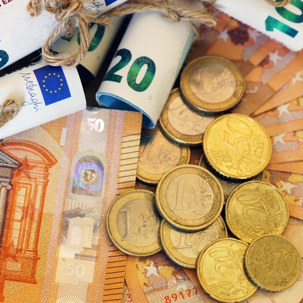 high-angle-view-some-rolled-banknotes-coins-more-banknotes