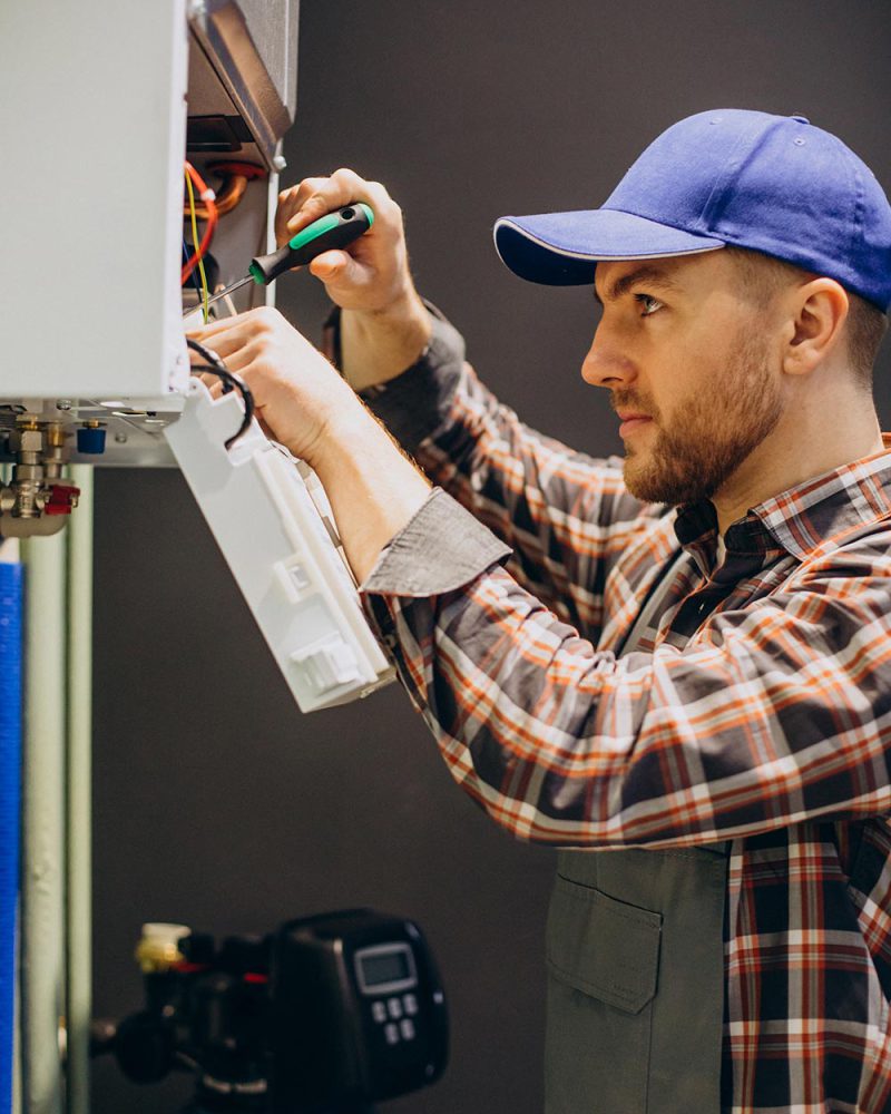 Service man adjusting house heating system